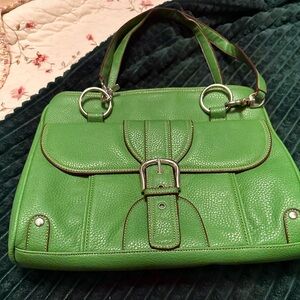Vintage green purse with three middle pockets and one front snap pocket.